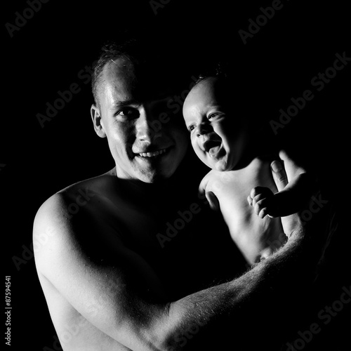 Black and white portrait of father and his newborn son