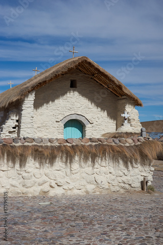 Historic church in the small village of Guallatire on the Altiplano in the Arica y Parinacota Region of Chile. The village sits at the base of the active Guallatire Volcano. photo