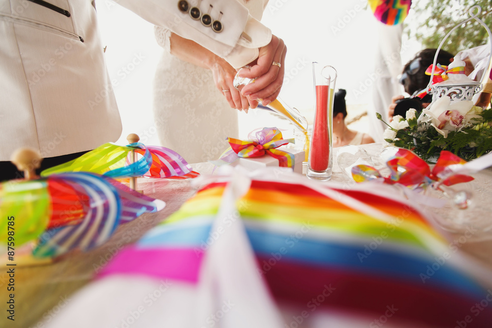 beautiful  gorgeous blonde bride  and stylish groom, hawai  colorful sand ceremony  on cyprus