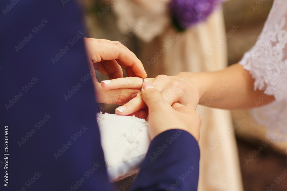 Obraz premium wonderful stylish rich happy bride and groom put rings at a wedding ceremony in garden near arch with flowers Montenegro