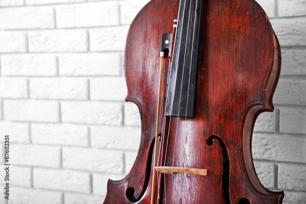 Cello on bricks wall background