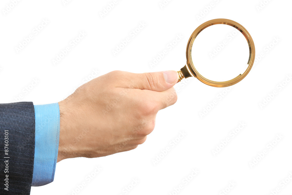 Male hand holding magnifying glass isolated on white Male hand holding magnifying glass isolated on white