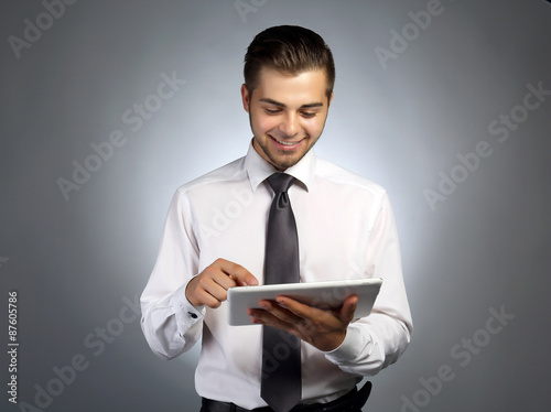 Handsome businessman holdin...