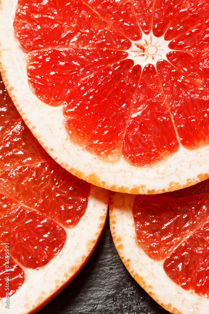 Slices of red grapefruit, top view, selective focus Slices of red grapefruit, top view, selective focus
