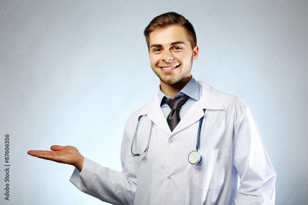 Male doctor with stethoscope on blue background Male doctor with stethoscope on blue background