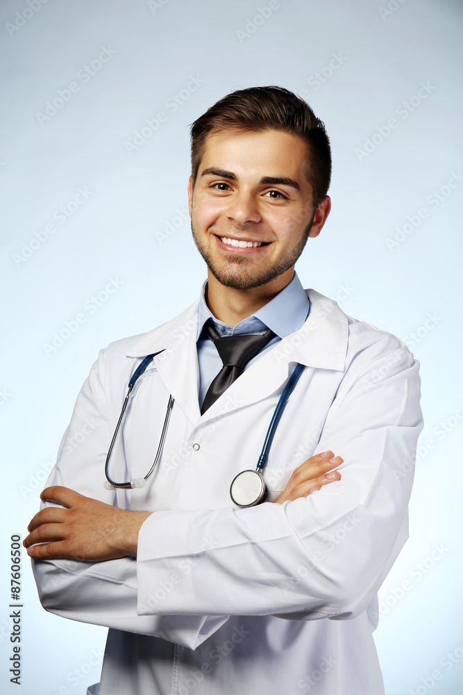 Male doctor with stethoscope on blue background Male doctor with stethoscope on blue background