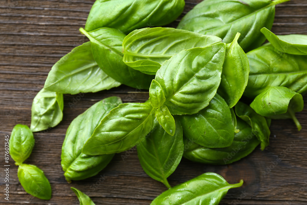 Fototapeta premium Green fresh basil on wooden background