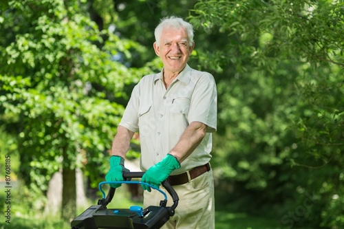 Senior man with lawn mower