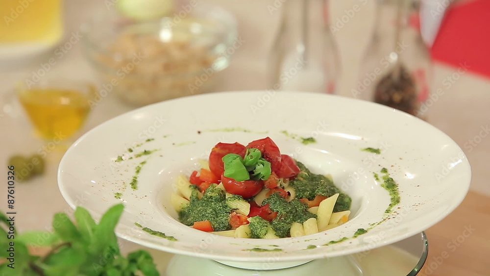 Presentation of Pasta with Green Pesto, Basil and Red Cherry Presentation of Pasta with Green Pesto, Basil and Red Cherry