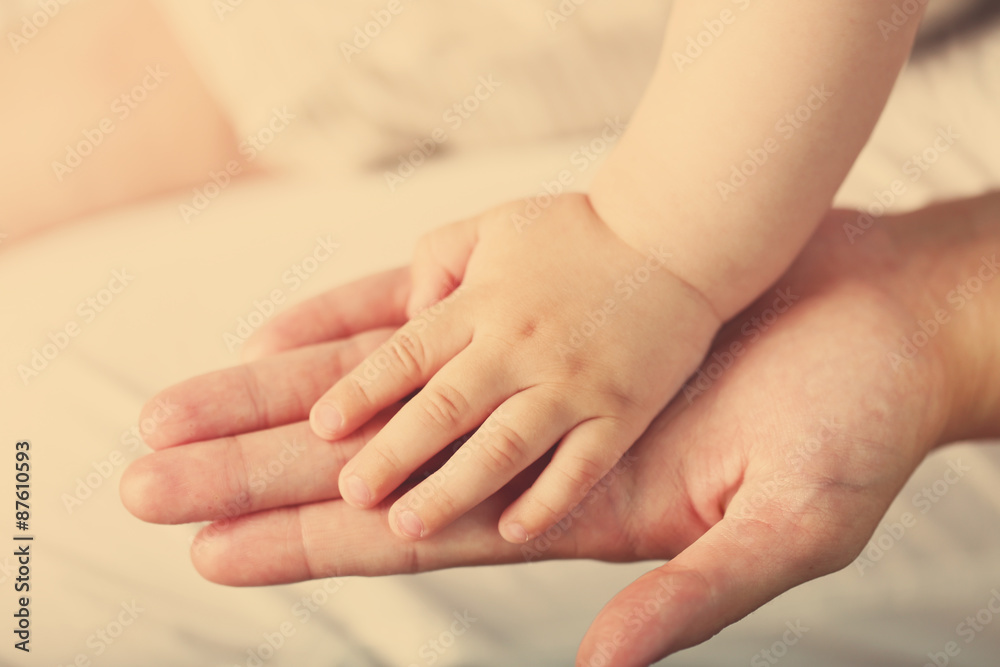 Adult and baby hands, closeup Adult and baby hands, closeup