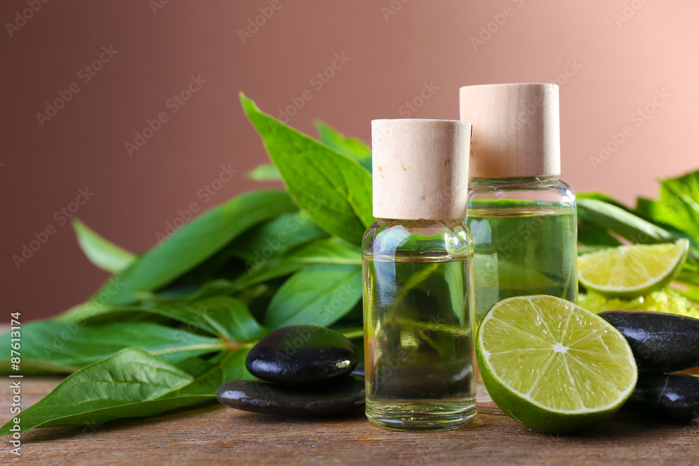 Spa still life in green color on wooden table on brown background Spa still life in green color on wooden table on brown background