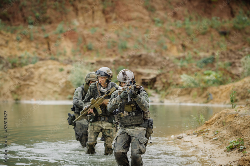 Military team crossing the river under fire Military team crossing the river under fire