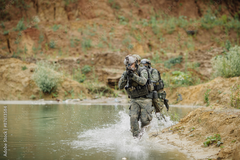 Military team crossing the river under fire