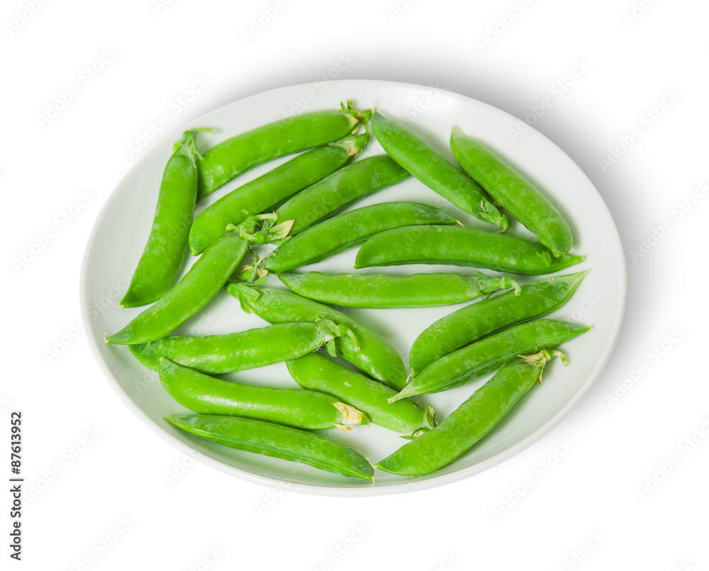 Several pods of peas on a white plate Several pods of peas on a white plate