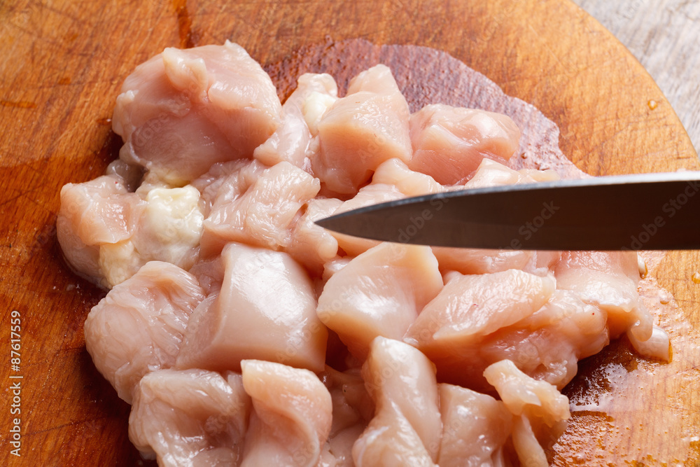 Chicken cubes diet on the kitchen cutting board Chicken cubes diet on the kitchen cutting board