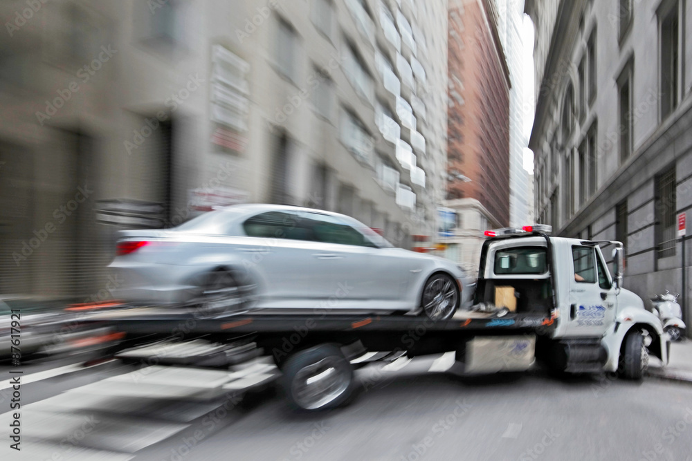 tow truck delivers the damaged vehicle