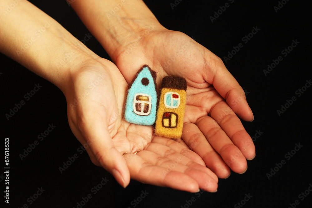 toy houses in female hands toy houses in female hands