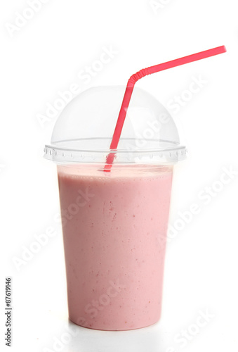 Plastic cup of milkshake with strawberries isolated on white