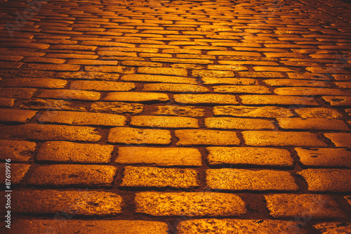 Fényképezés orange cobblestone road  with sunlight in evening