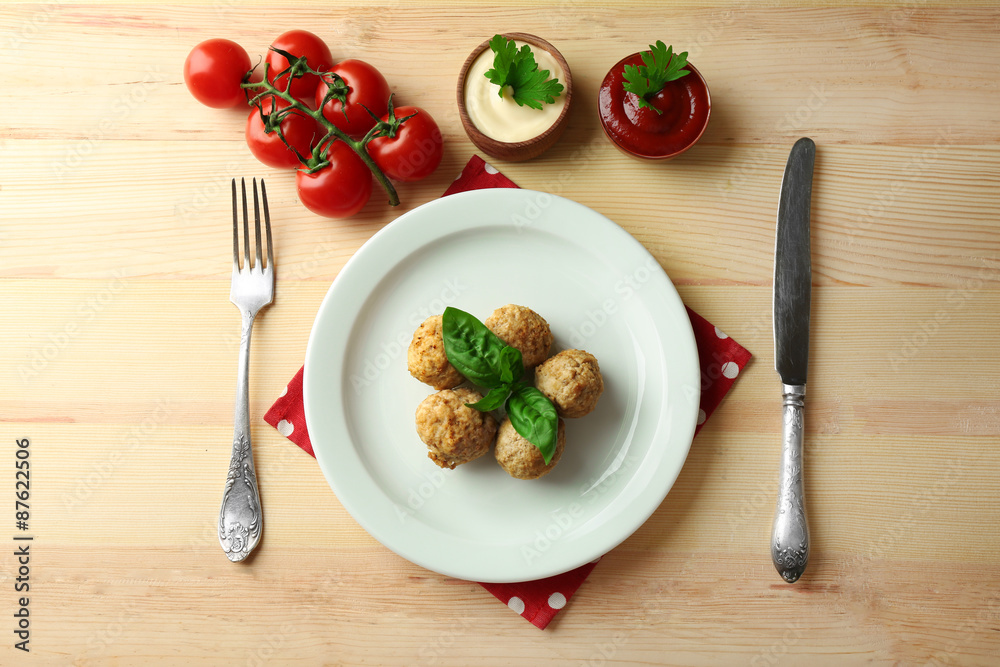 Meat balls on plate, on wooden table background
