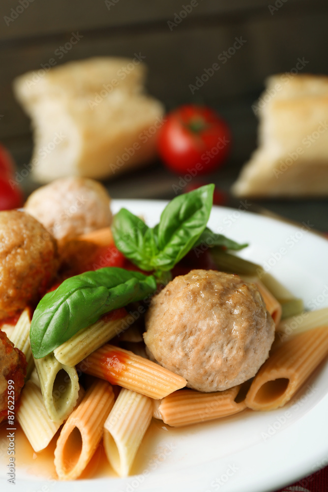Pasta with meatballs on plate, on wooden table background Pasta with meatballs on plate, on wooden table background