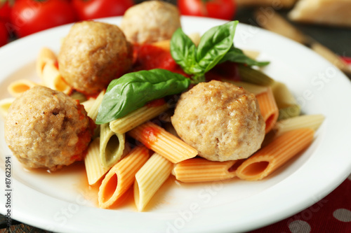 Pasta with meatballs on plate, on wooden  table background
