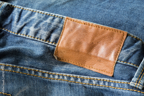 brown leather tag on blue jeans