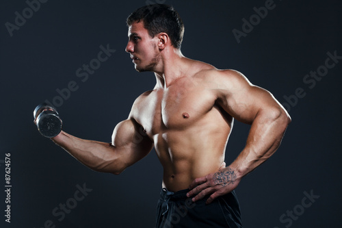 Bodybuilder showing his back and biceps muscles, personal fitnes