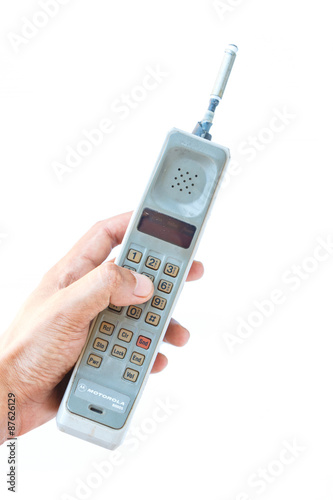 man hand holding vintage mobile phone Isolated on white background.