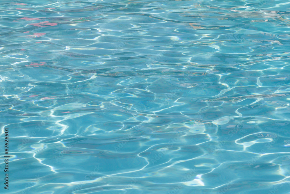 Blue pool water with sun reflections