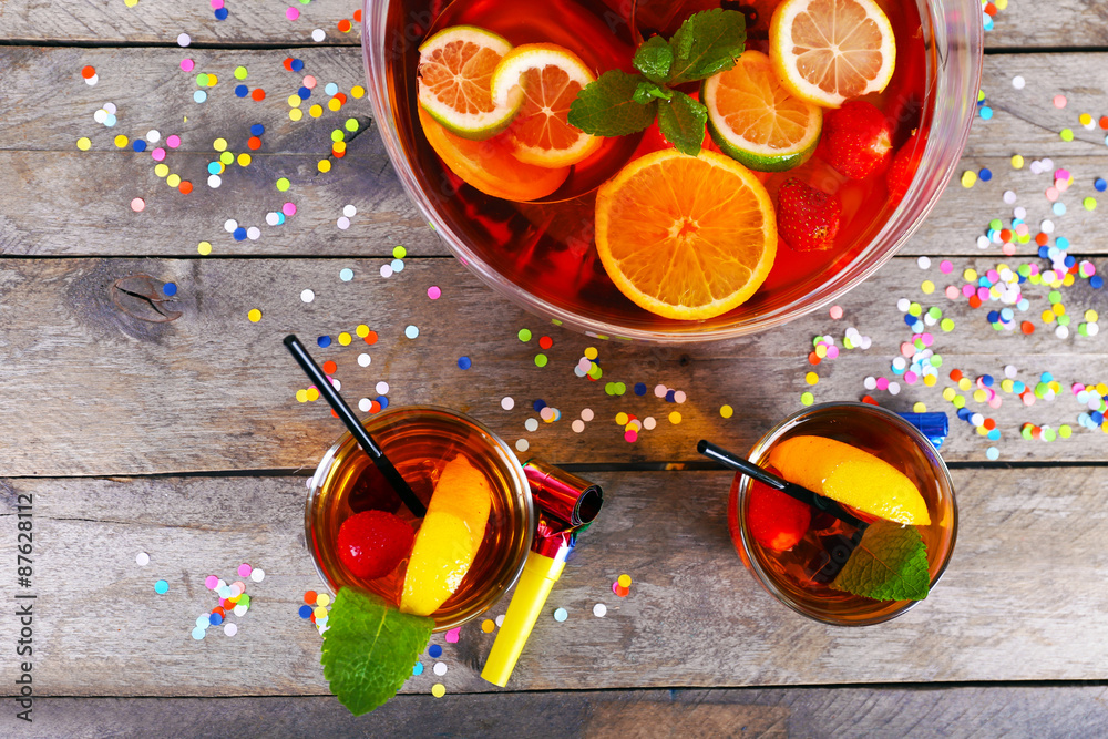 Sangria in bowl and glasses on wooden table close up