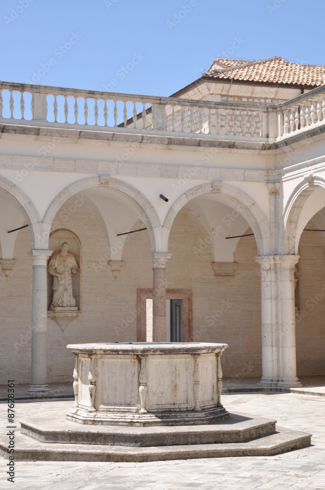Fototapeta premium Courtyard Benedictine Monastery at Monte Cassino, a stone fountain and arcades