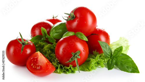 Cherry tomatoes with basil and lettuce close up