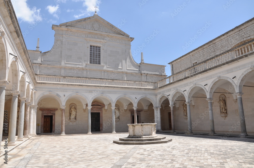 Courtyard Benedictine Monastery at Monte Cassino, a stone fountain and arcades