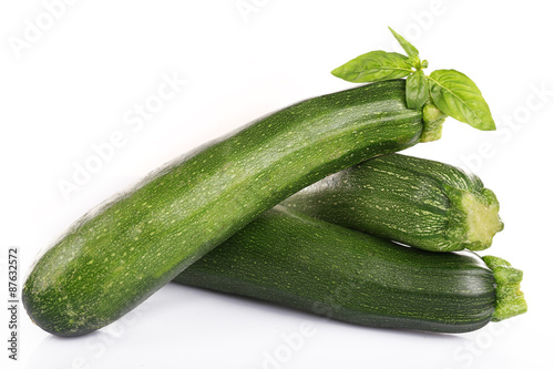 Fresh zucchini with basil isolated on white