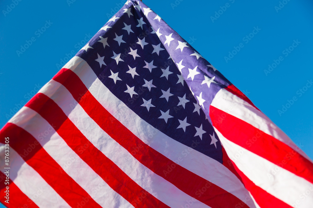 Fototapeta premium American flag over blue sky