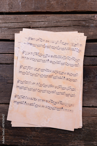 Music sheets on wooden background