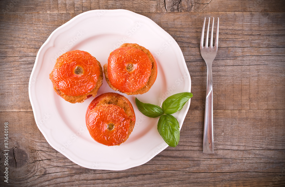 Stuffed tomatoes on a white plate. Stuffed tomatoes on a white plate.