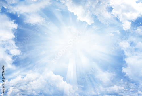 Bright rays of light in blue sky