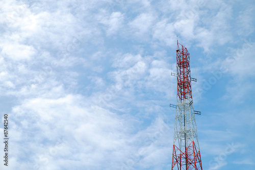 red and white color antenna repeater tower on blue sky