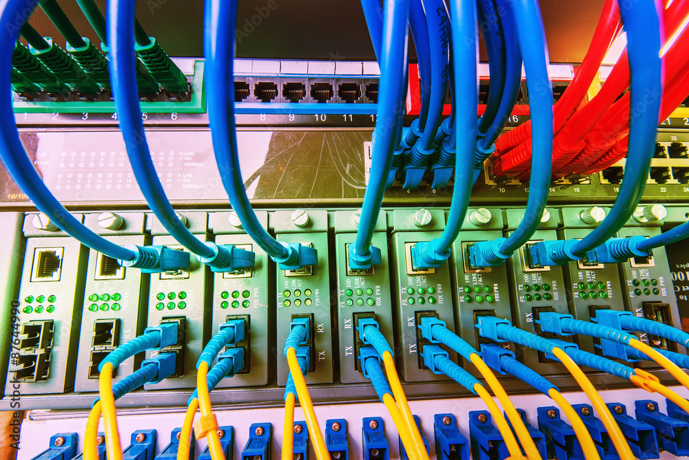 Fiber Optic cables connected to an optic ports and Network cable Fiber Optic cables connected to an optic ports and Network cable
