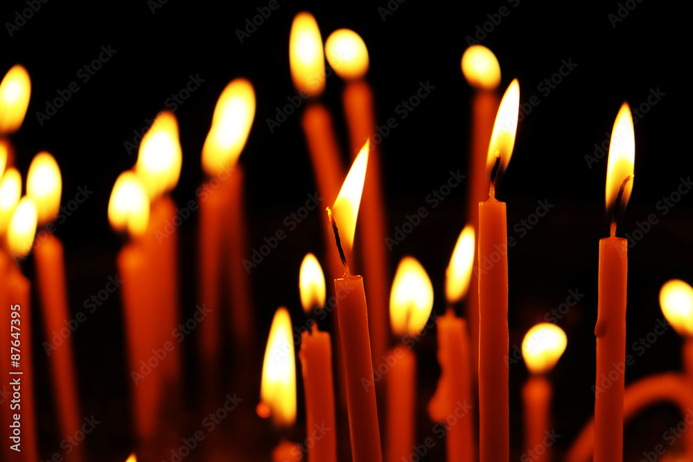 Burning church candles in dark Burning church candles in dark