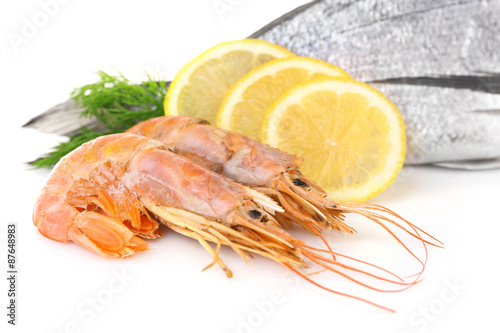 Fresh dorado fish with shrimps, dill and lemon isolated on white