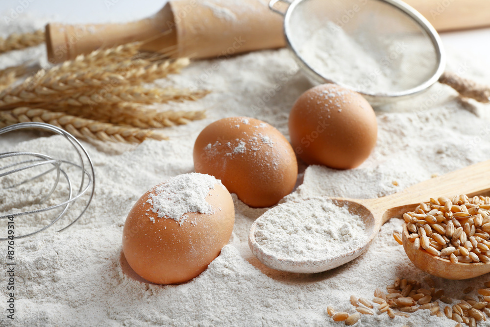 Wheat and eggs on white flour background Wheat and eggs on white flour background
