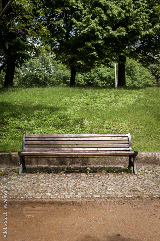 Park Bench. A conventional park bench setting in an urban park. Hamburg, Germany. Park Bench. A conventional park bench setting in an urban park. Hamburg, Germany.