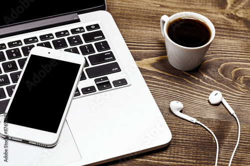 Mobile phone and laptop on the table