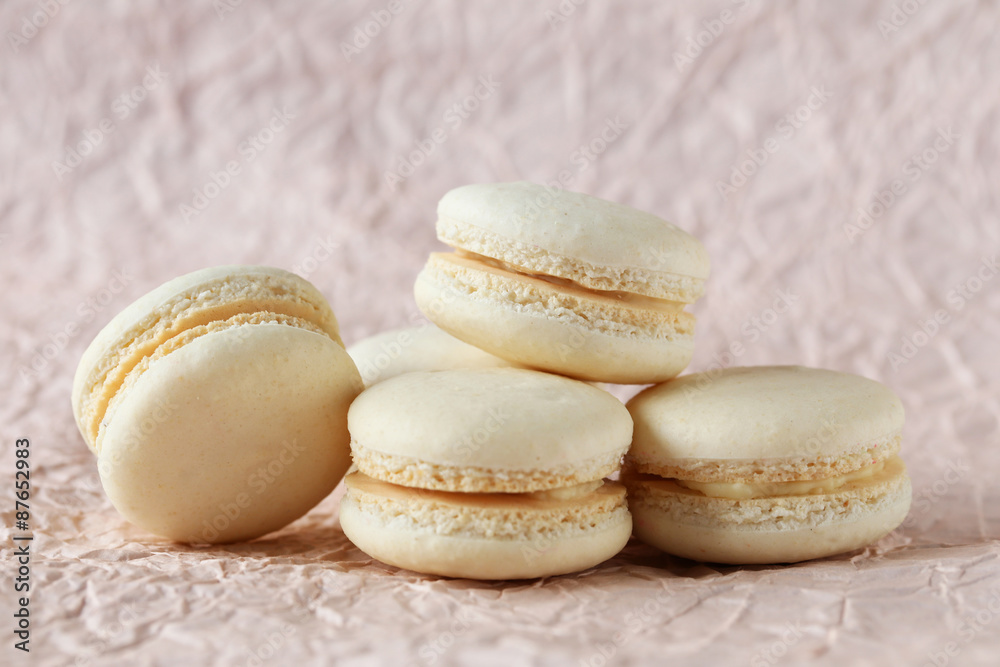 Beige macarons on paper background