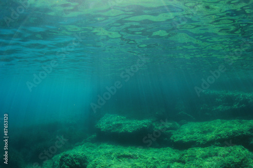 Underwater blue background in ocean with sunlight