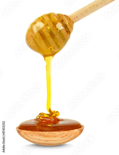 honey dripping into a bowl isolated on white background