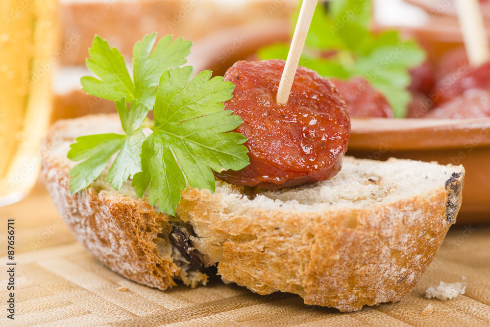 Chorizo a la Sidra Spanish spicy chorizo sausages cooked in cider on top of crusty bread